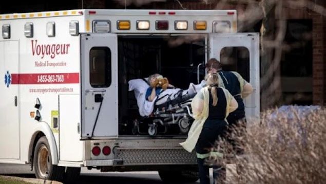 Paramedics transport a resident from Midland Gardens Care Community in Toronto